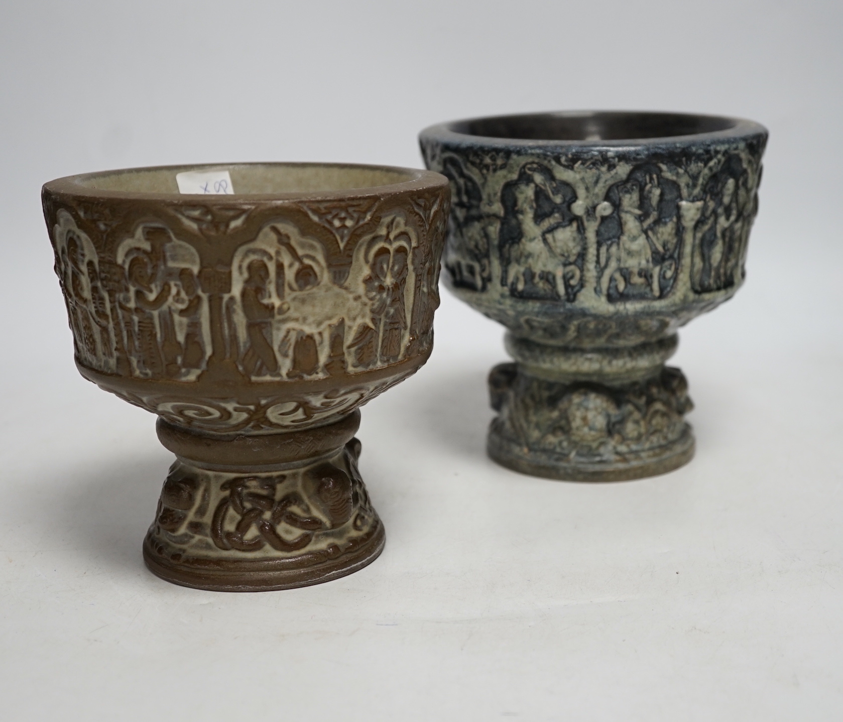 Two Michael Andersen & Sons, Denmark miniature stoneware fonts, one with label to the base; MA&S, both with the same impressed design of the life of Christ, tallest 14.5cm